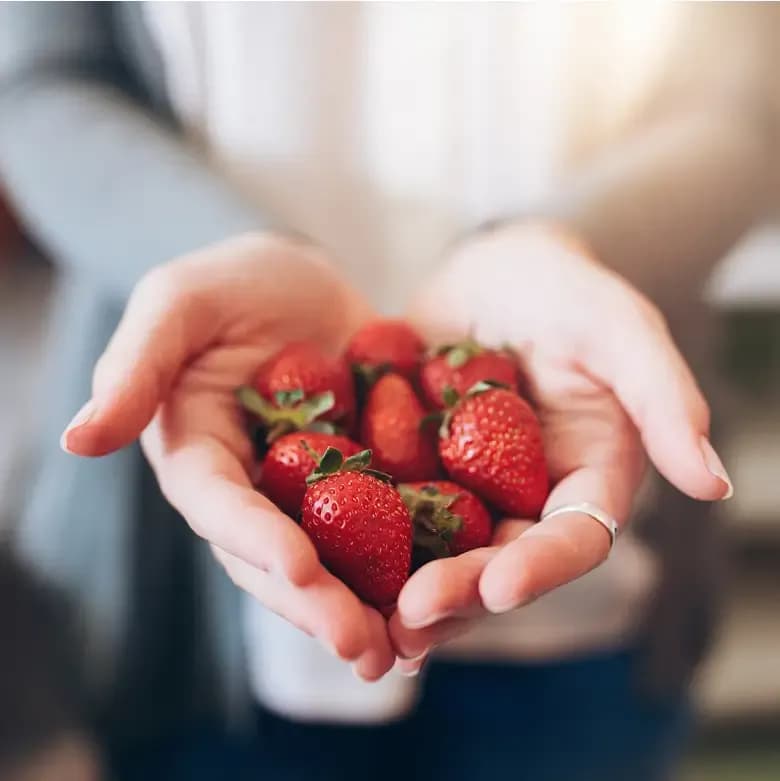 fresh strawberries held in hands